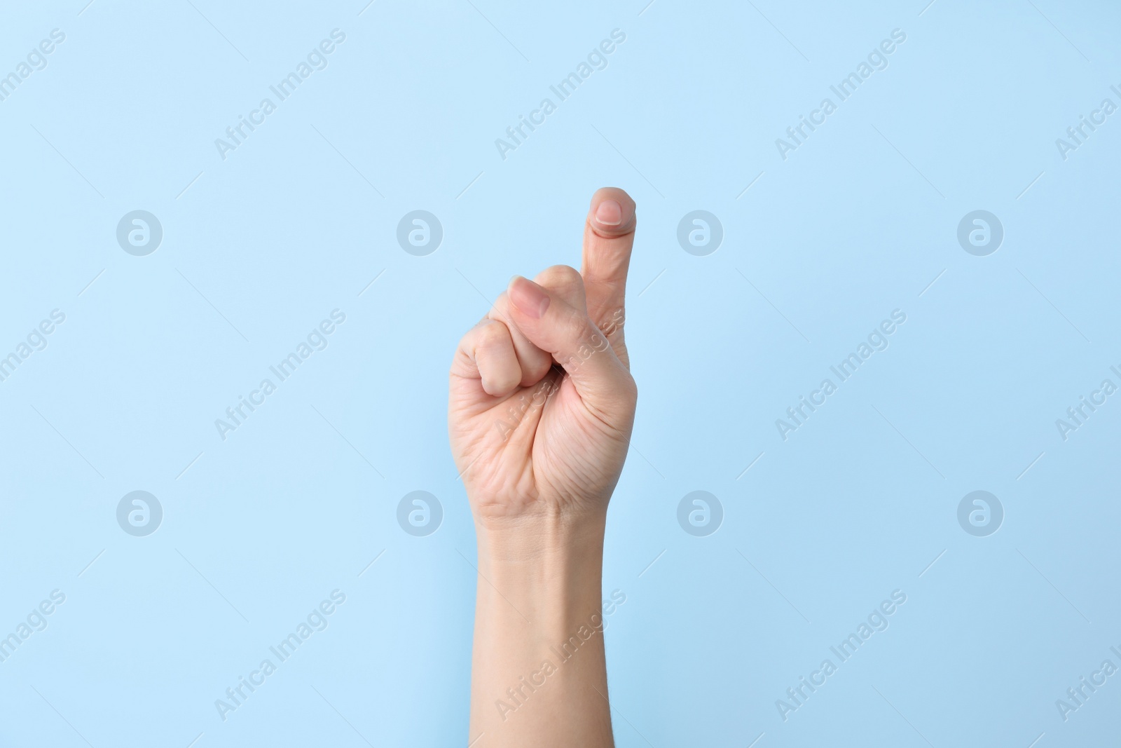 Photo of Woman showing X letter on color background, closeup. Sign language