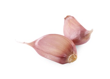 Photo of Unpeeled cloves of garlic isolated on white