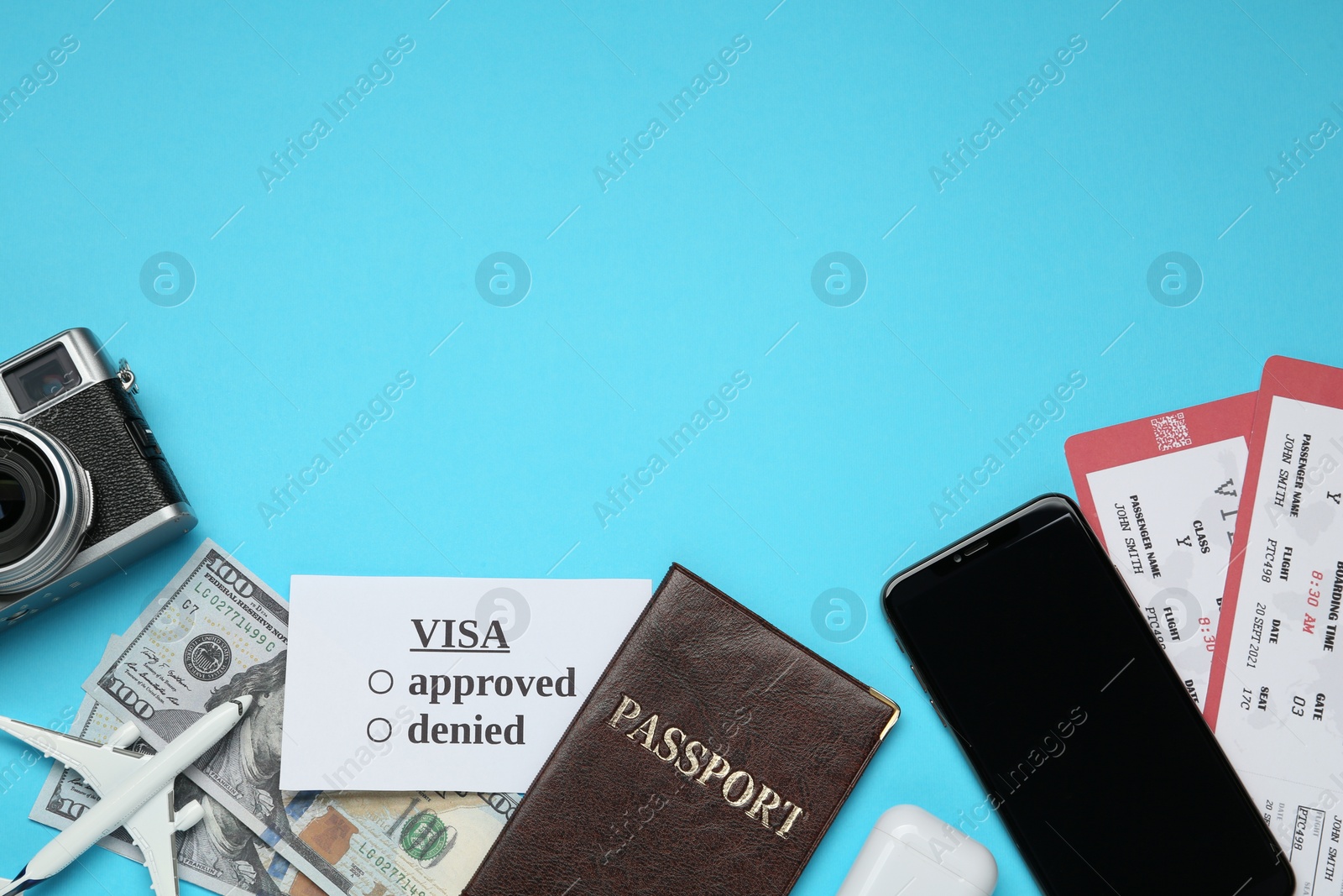 Photo of Flat lay composition with passport, toy plane and tickets on light blue background, space for text. Visa receiving