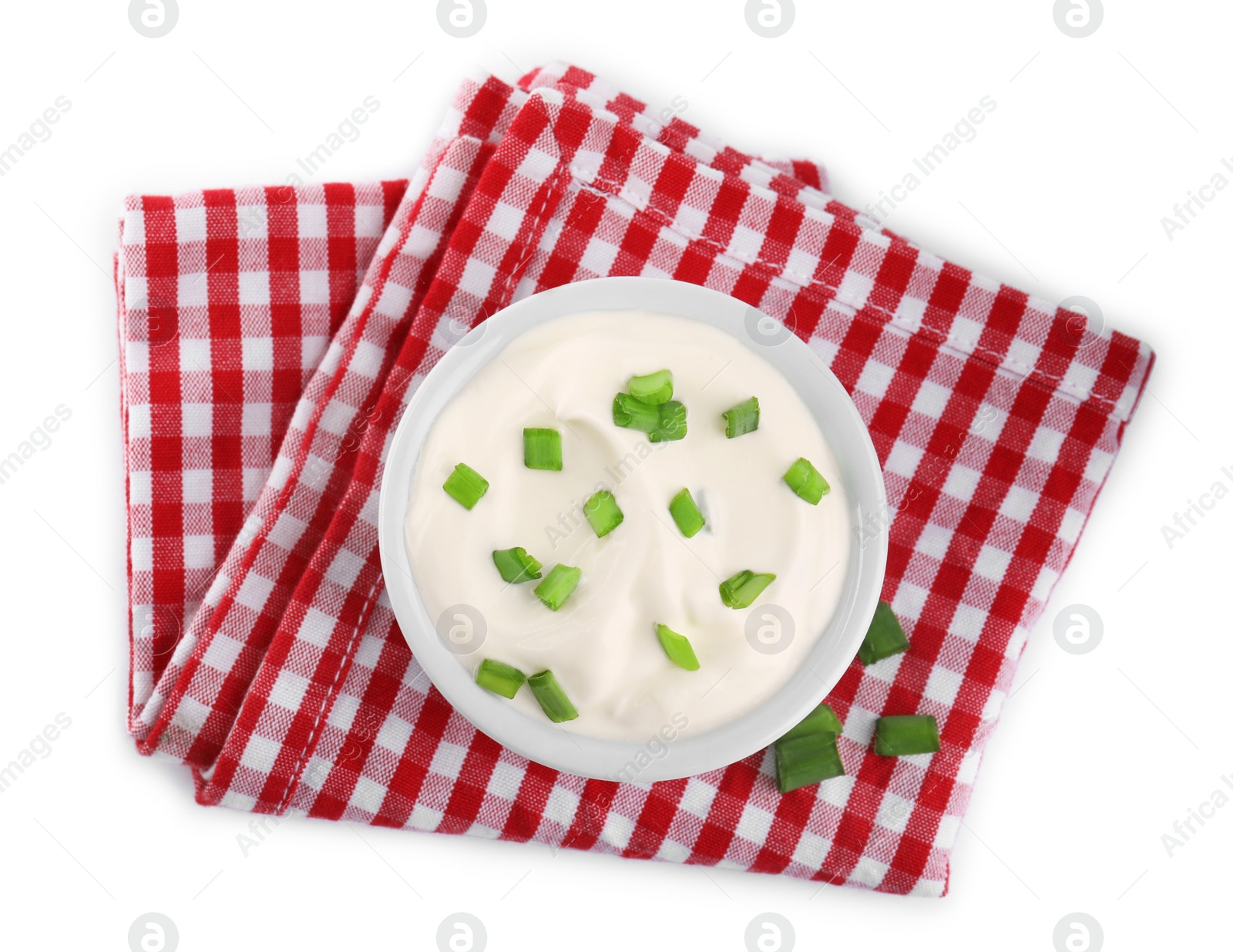 Photo of Fresh sour cream with onion and fabric on white background, top view