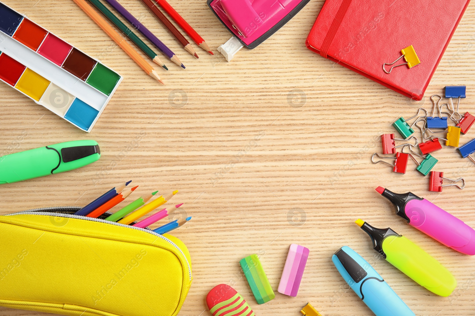 Photo of Different school stationery with space for design on wooden background, flat lay