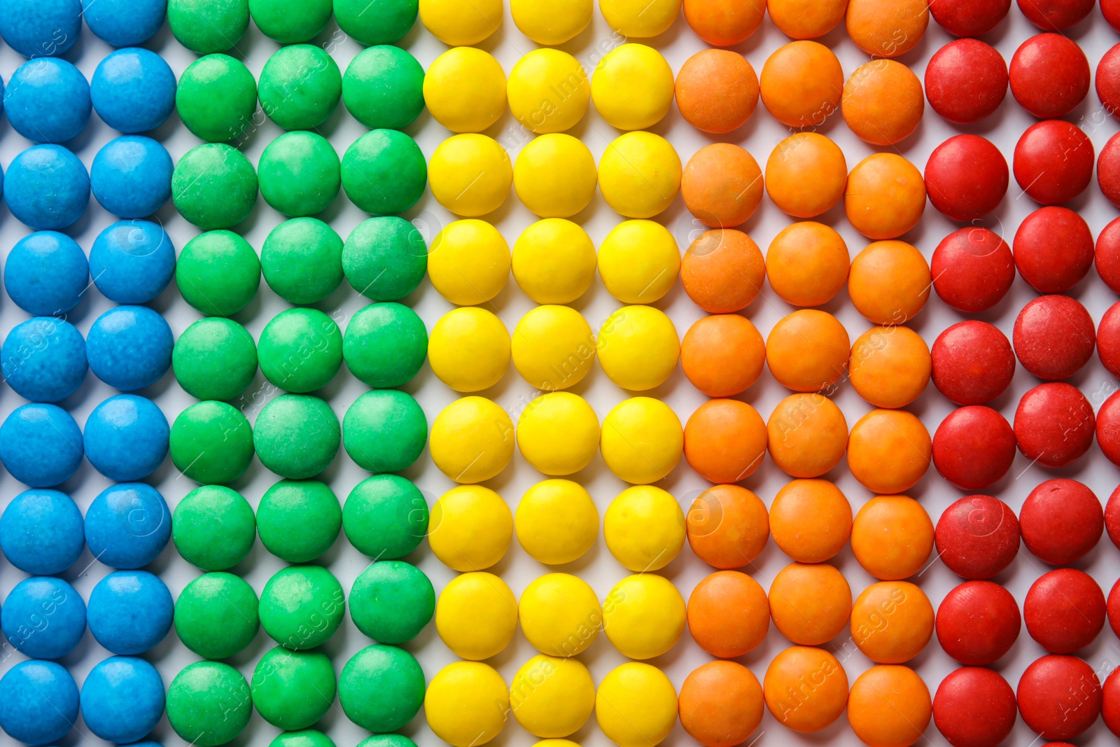 Photo of Many colorful candies as background, top view