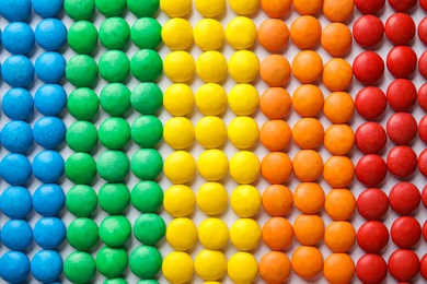 Many colorful candies as background, top view