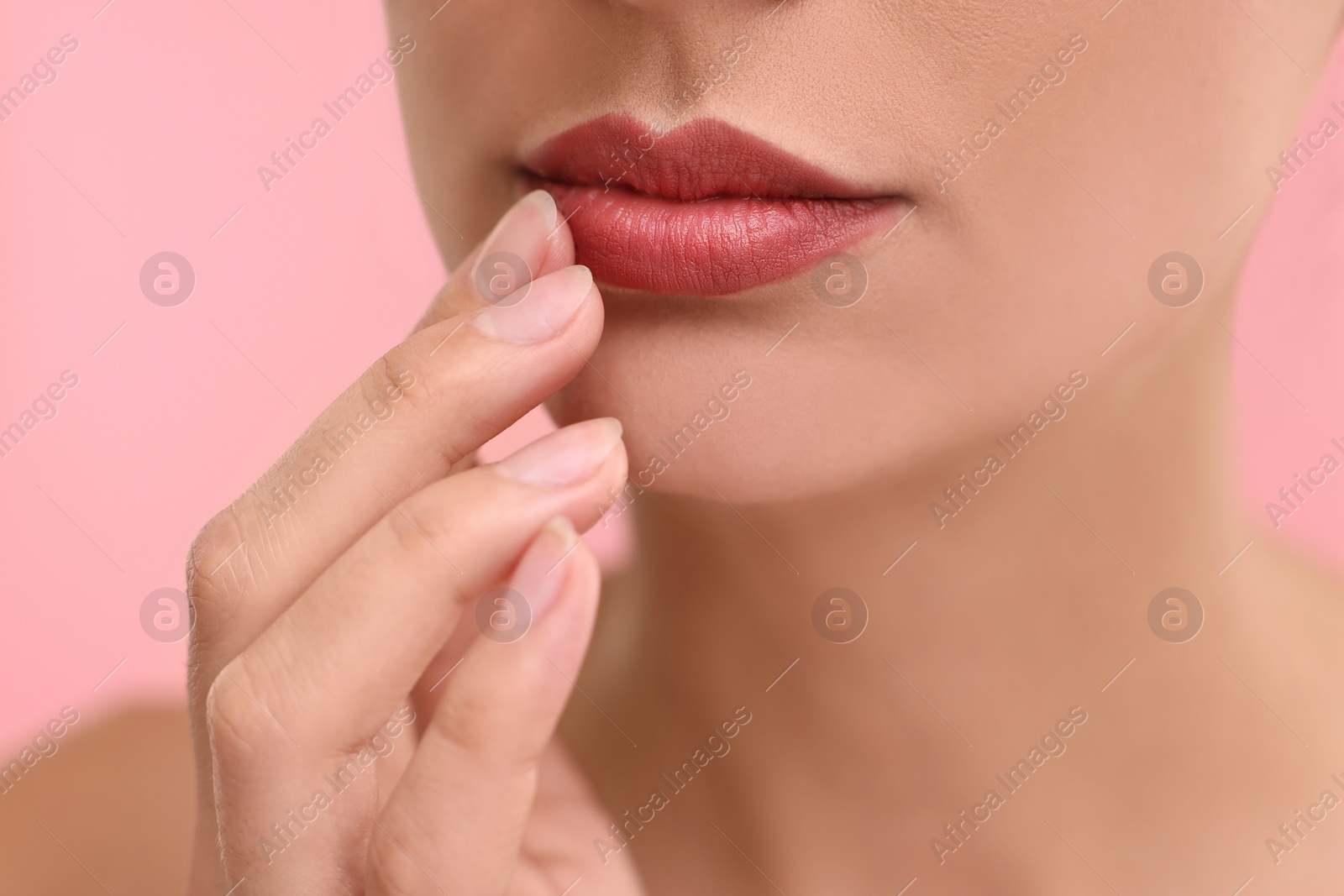 Photo of Woman with beautiful lips on pink background, closeup