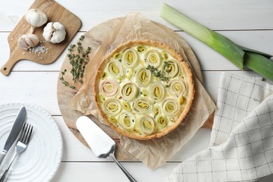 Flat lay composition with tasty leek pie and products on white wooden table