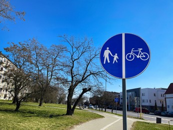 Photo of Road sign Shared Lane Bicycles and Pedestrians on sunny day