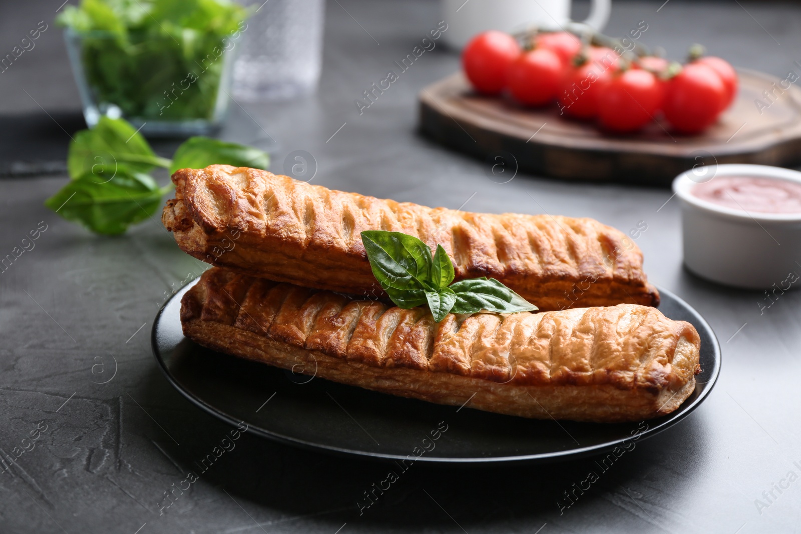 Photo of Fresh delicious puff pastry served on grey table