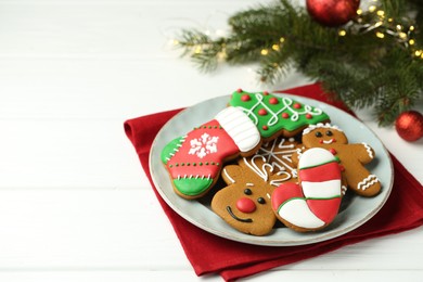 Tasty homemade Christmas cookies on white wooden table. Space for text