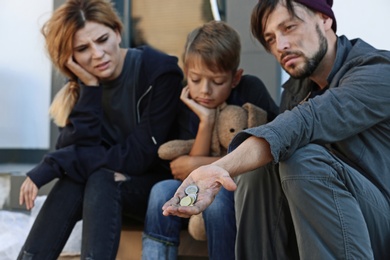 Photo of Poor homeless family begging on city street