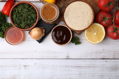 Photo of Different fresh marinades and ingredients on white wooden table, flat lay. Space for text