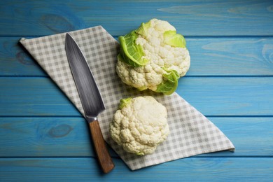 Fresh whole cauliflowers on light blue wooden table, top view