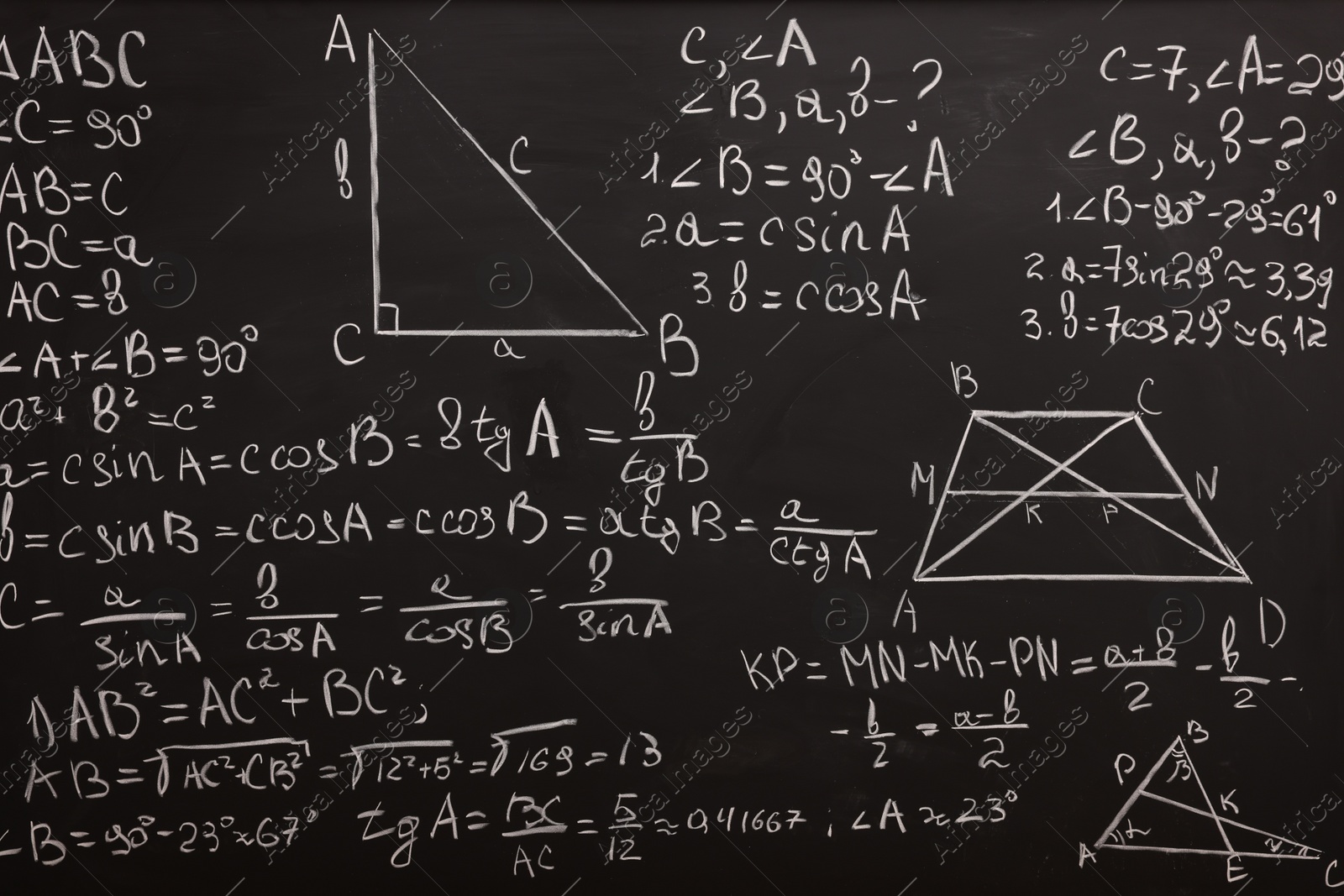 Photo of Different mathematical formulas written with chalk on blackboard