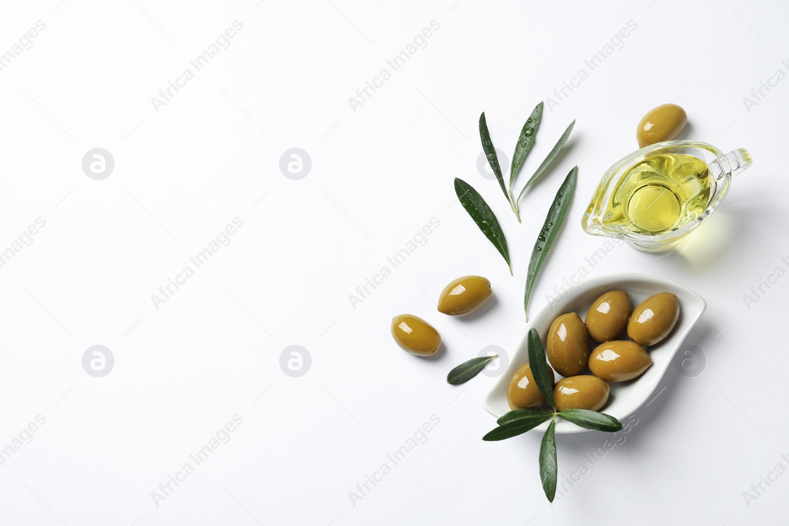 Photo of Beautiful composition with oil and ripe olives on white background