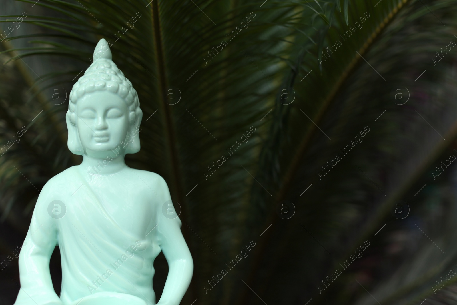 Photo of Decorative Buddha statue outdoors, closeup. Space for text