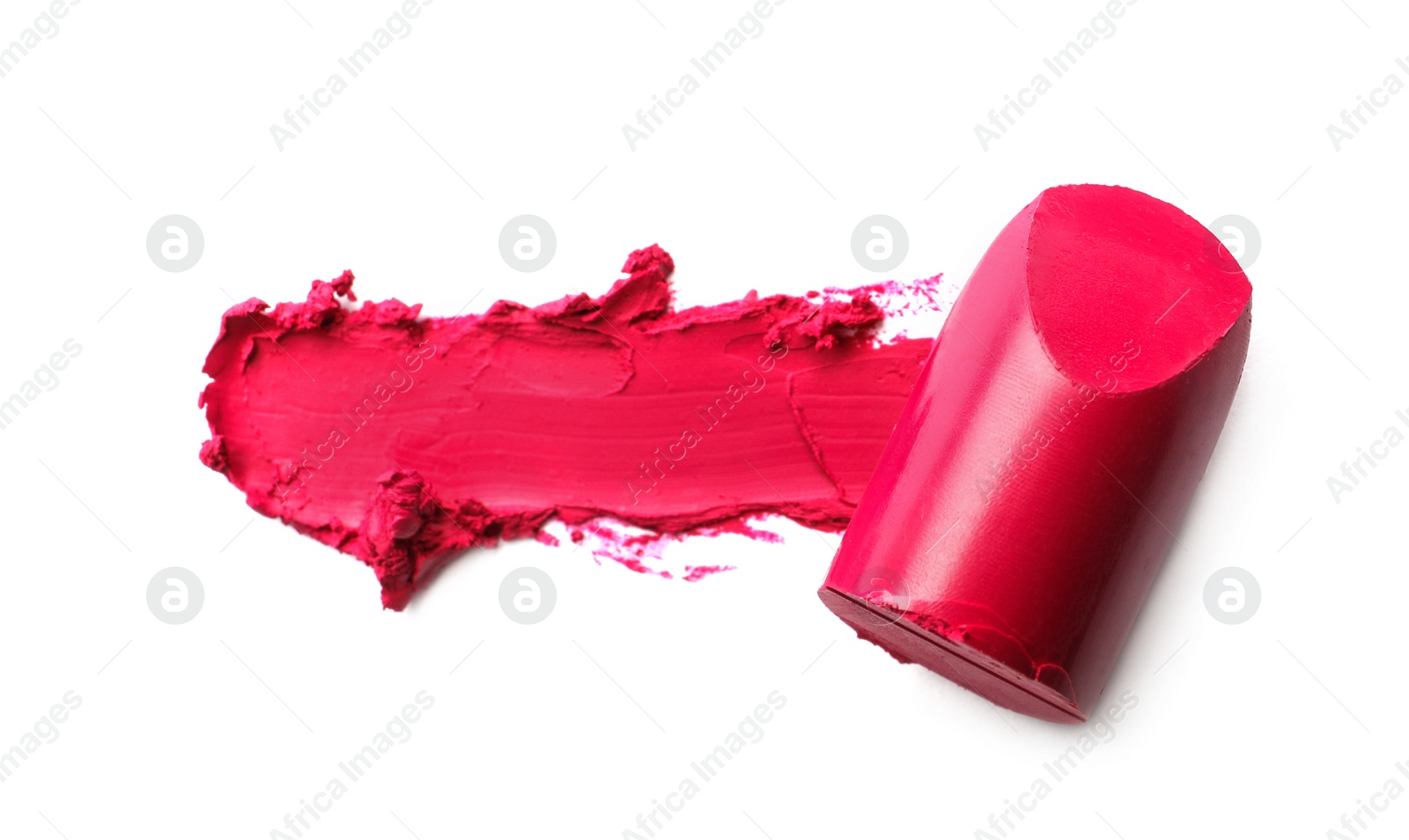 Photo of Bright lipstick and smear on white background, top view