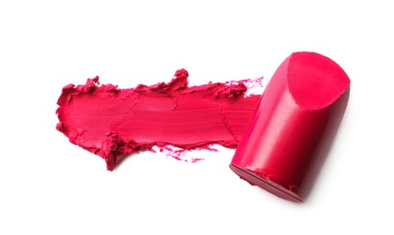 Photo of Bright lipstick and smear on white background, top view