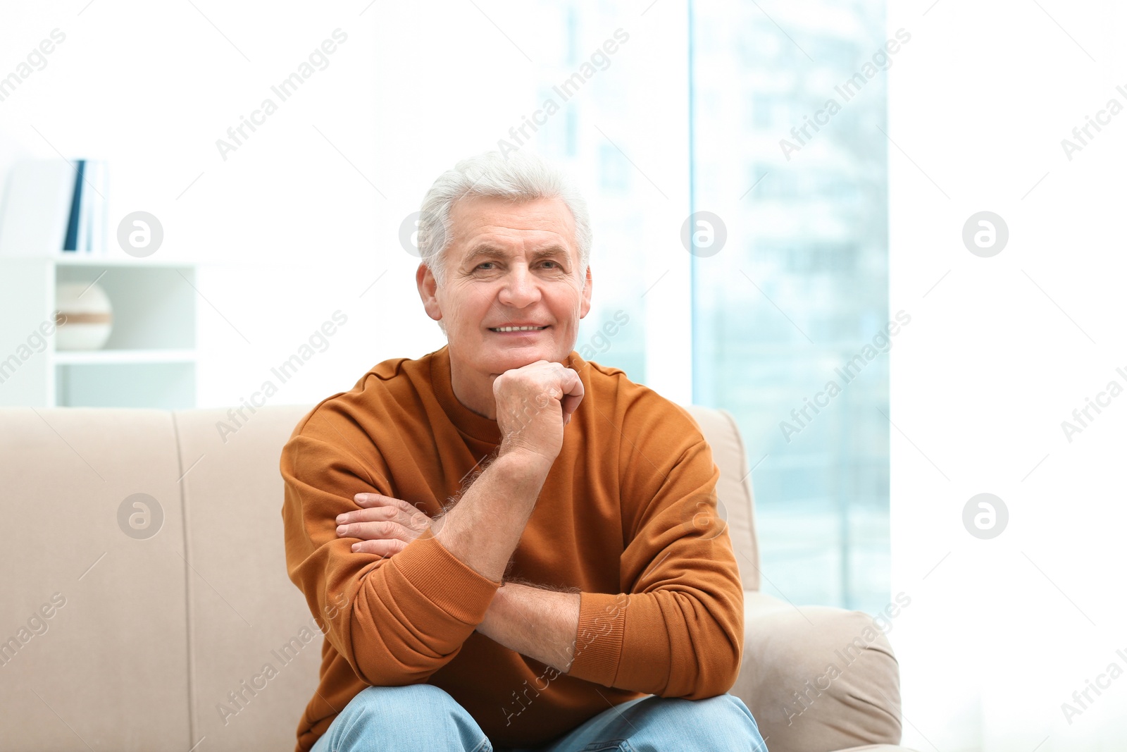 Photo of Portrait of handsome mature man on sofa indoors