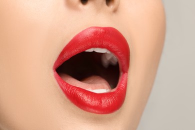 Photo of Woman with red lipstick on light background, closeup