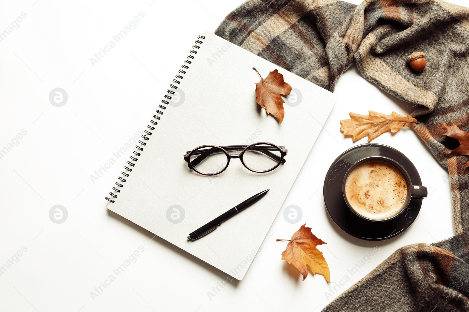 Photo of Flat lay composition with notebook, cup of coffee and warm blanket on white background. Space for text