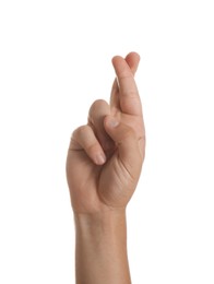 Teenage boy crossing fingers on white background, closeup