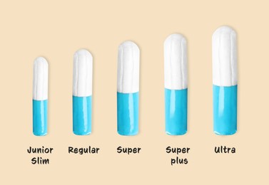 Tampons of different sizes on beige background 