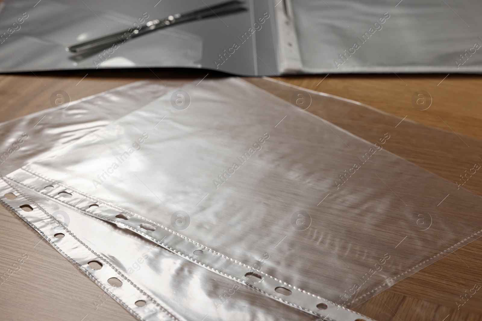 Photo of Punched pockets on wooden table, closeup view