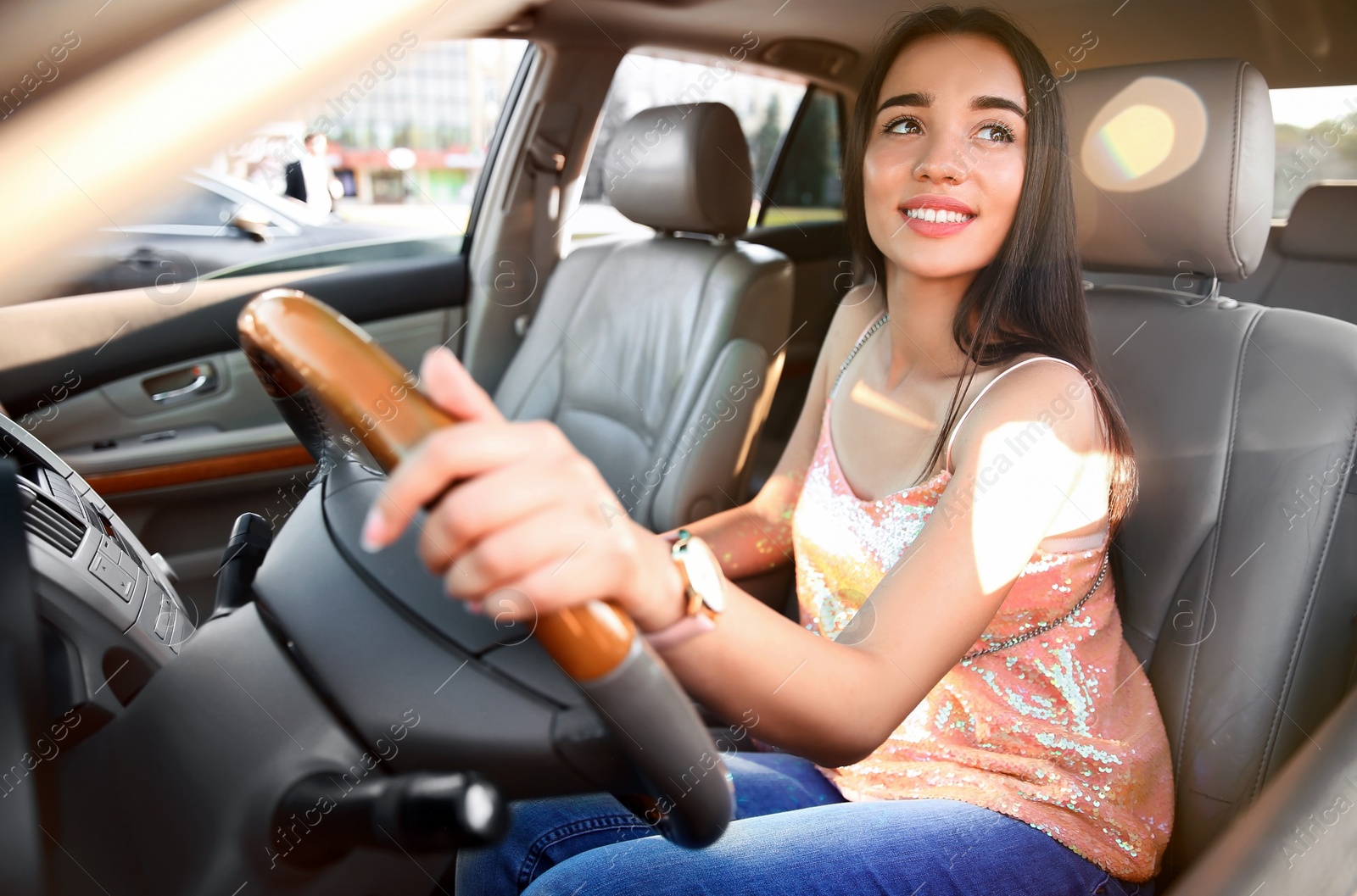 Photo of Young woman on driver's seat of car