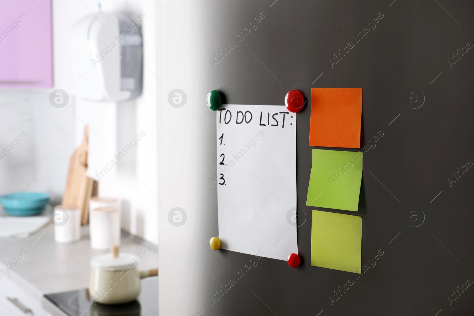 Photo of Paper notes, to-do list and magnets on refrigerator door in kitchen