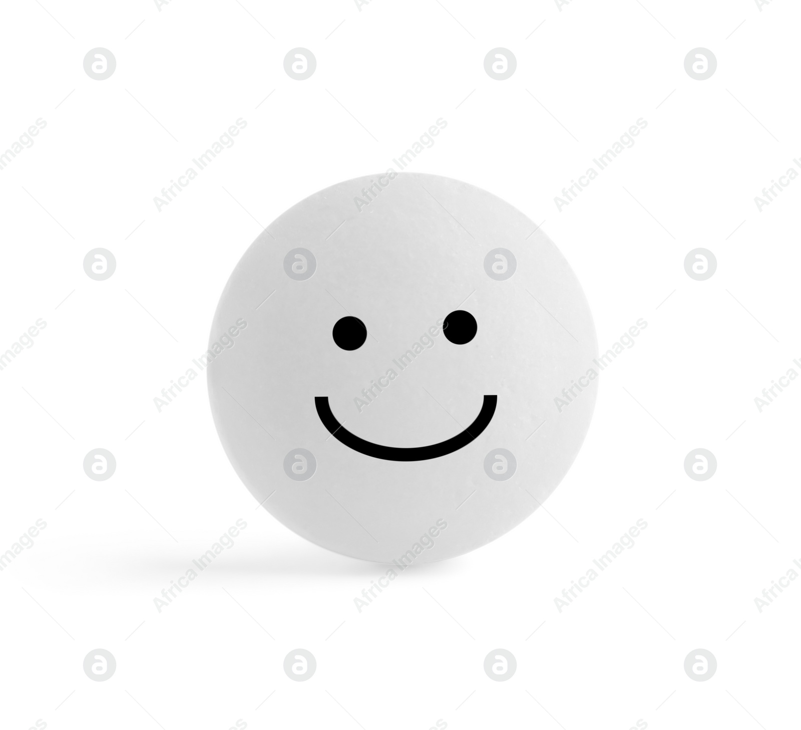 Image of One round pill with smiling face on white background