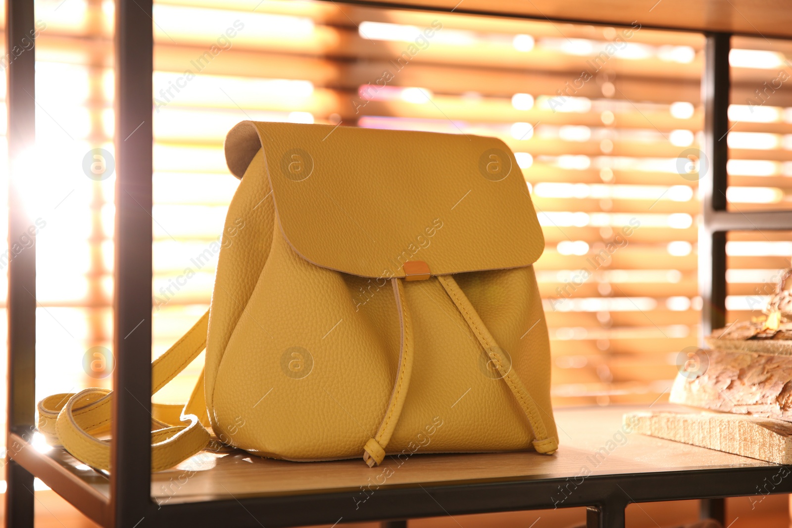 Photo of Stylish woman's bag on shelf in boutique