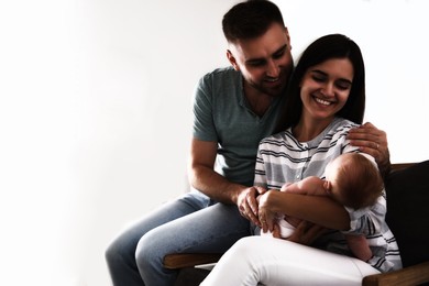 Happy family with their cute baby on white background