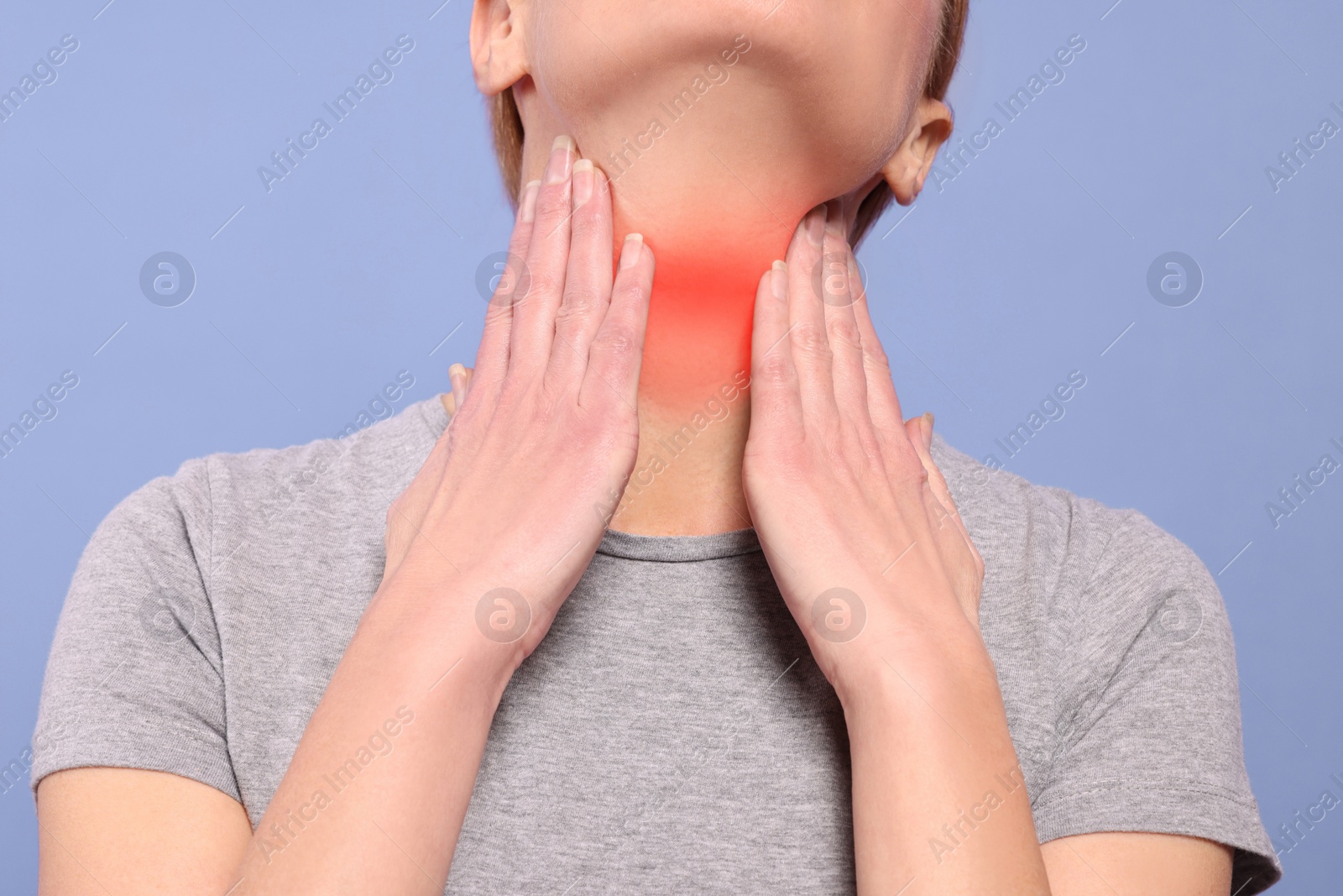 Image of Endocrine system. Woman doing thyroid self examination on purple background, closeup