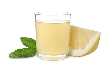 Photo of Glass of fresh pomelo juice, fruit and green leaves isolated on white