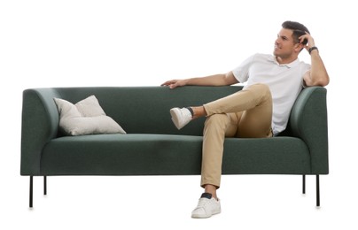 Photo of Man relaxing on comfortable green sofa against white background