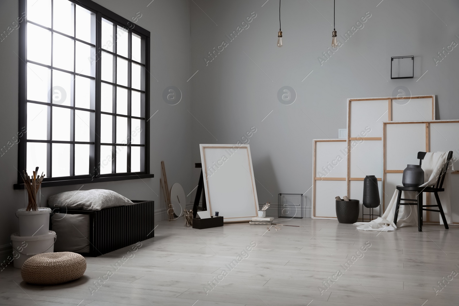 Photo of Stylish artist's studio interior with canvas and brushes