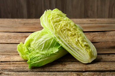 Photo of Fresh ripe Chinese cabbages on wooden table