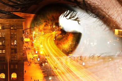 Double exposure of night cityscape and woman with beautiful eye, closeup