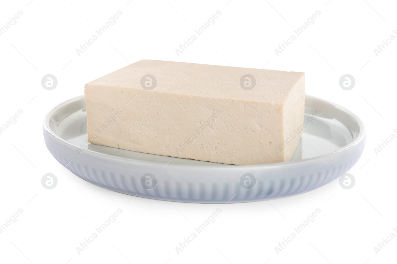 Photo of Plate with delicious raw tofu isolated on white