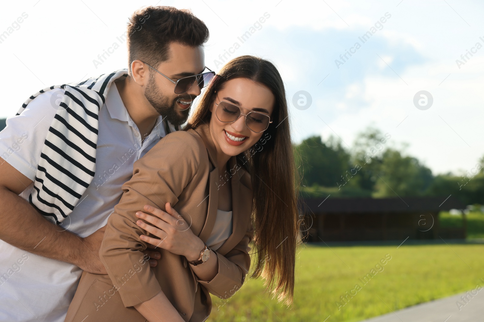 Photo of Romantic date. Beautiful couple spending time together in park, space for text