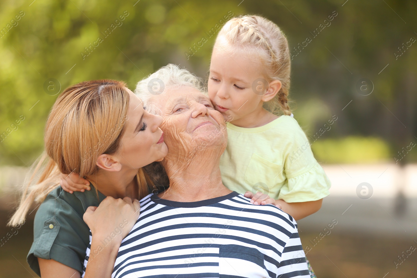Photo of Woman with daughter and elderly mother outdoors