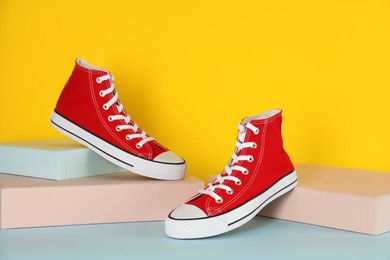 Photo of Pair of stylish sneakers on color background