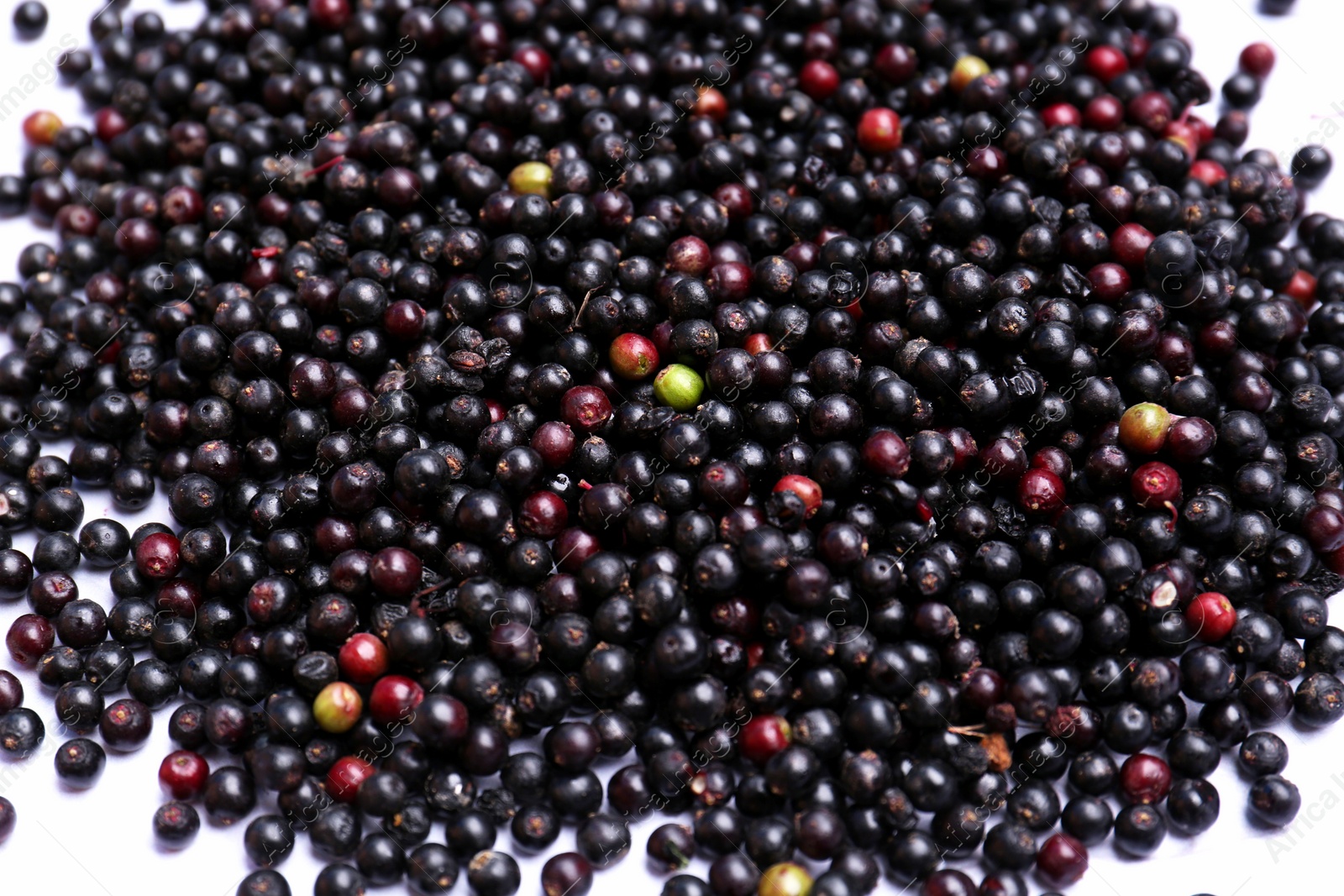 Photo of Pile of tasty elderberries (Sambucus) on table, top view