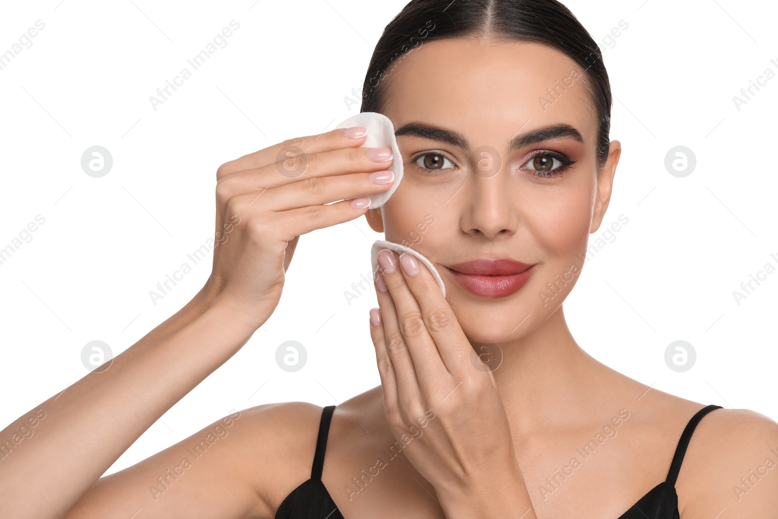 Photo of Beautiful woman removing makeup with cotton pads on white background