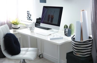 Comfortable workplace with computer on desk in home office