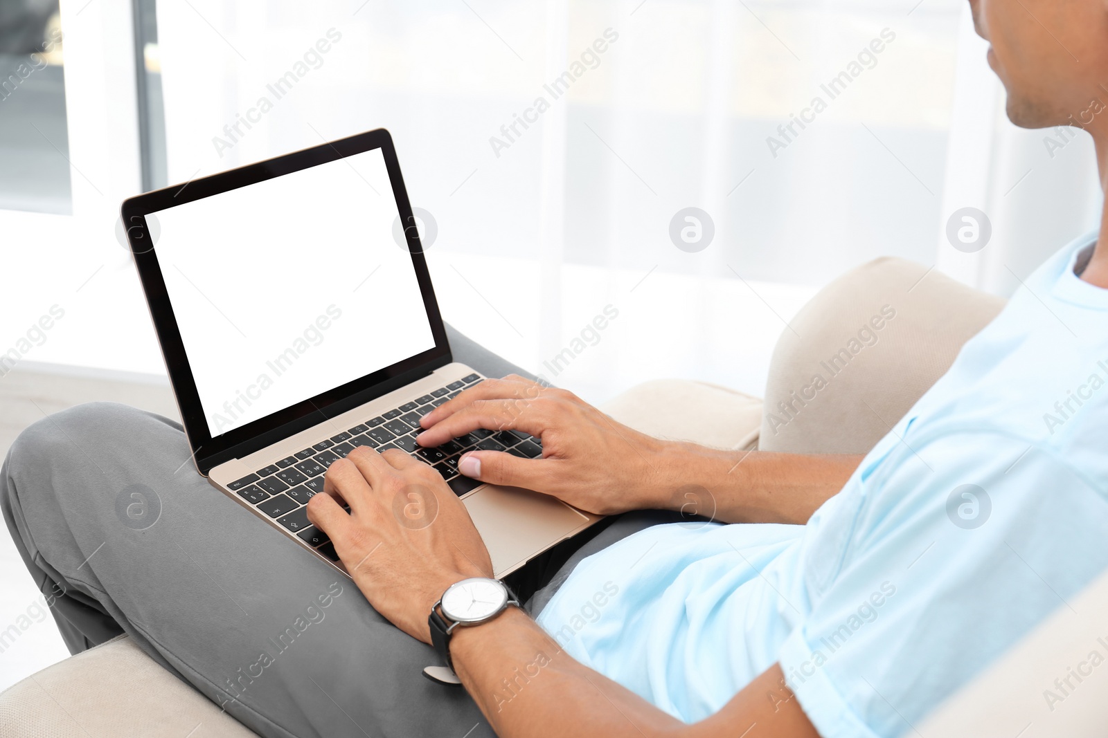 Image of Young man using modern computer at home, focus on hands. Space for design