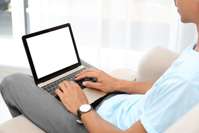 Image of Young man using modern computer at home, focus on hands. Space for design