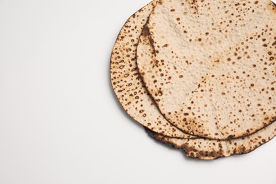 Photo of Tasty matzos on white background, top view. Passover (Pesach) celebration