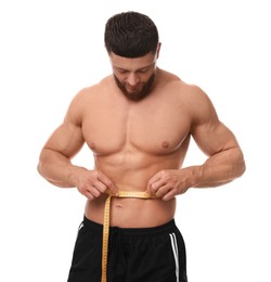 Photo of Athletic man measuring waist with tape on white background. Weight loss concept