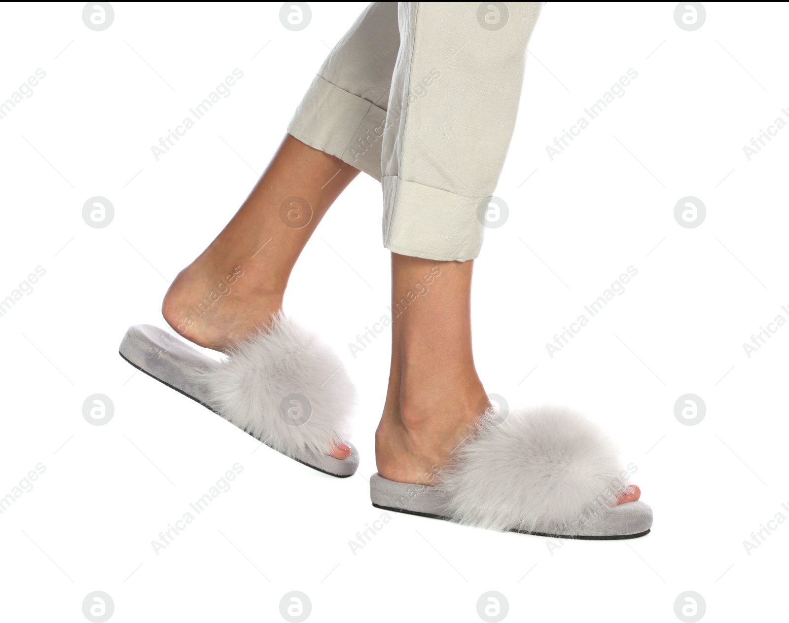 Photo of Woman in fluffy slippers on white background, closeup