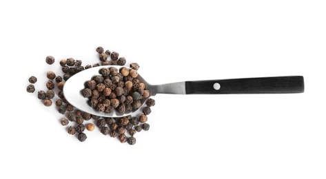 Photo of Spoon of black peppercorns isolated on white, top view